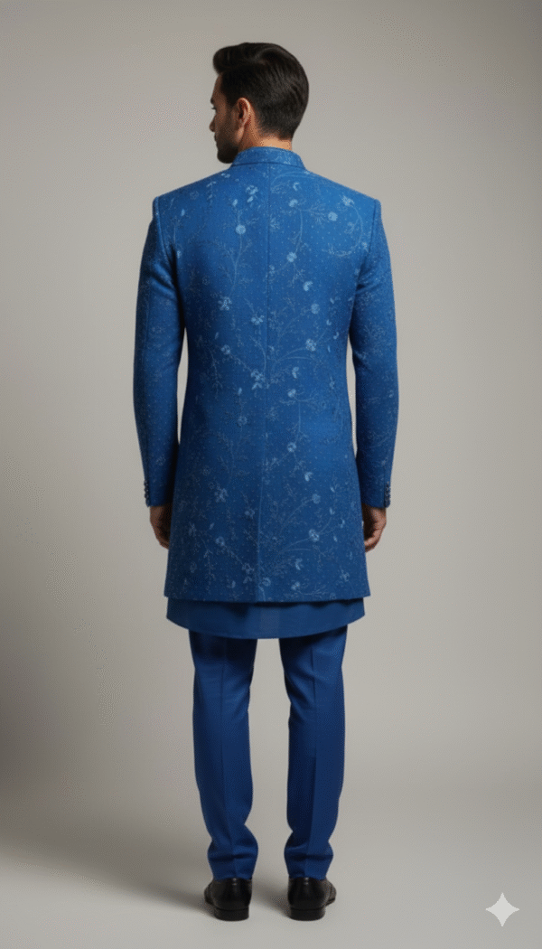 Teal blue Indo-Western set featuring intricate embroidery, paired with matching trousers, designed for festive and wedding occasions.