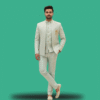 A man wearing a pastel mint green Indo-Western sherwani set with subtle textured embroidery, paired with matching trousers and ethnic juttis, styled with a Mandarin collar and gold brooch.