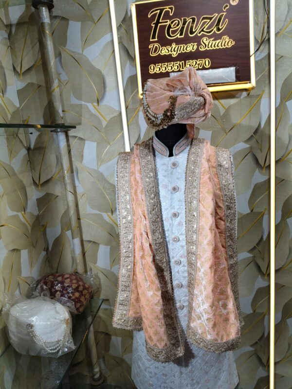 Elegant peach and silver embroidered sherwani with matching turban and stole displayed at Fenzi Designer Studio.