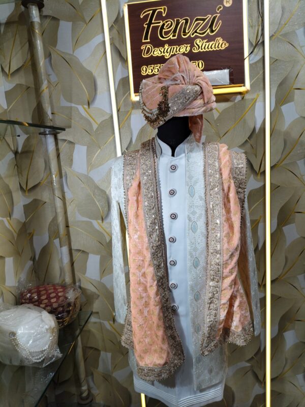 Elegant peach and white sherwani with embellished turban and dupatta displayed at Fenzi Designer Studio.