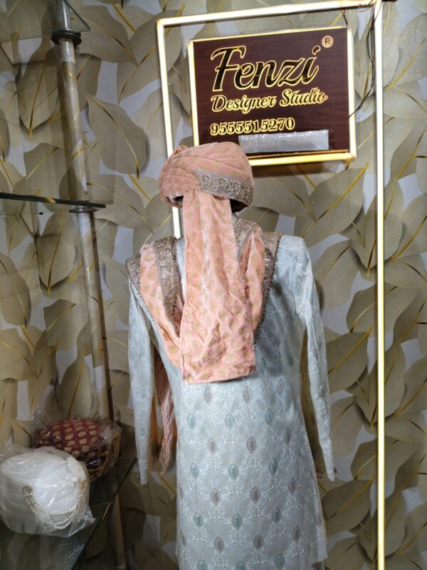 Elegant peach and white sherwani with embellished turban and dupatta displayed at Fenzi Designer Studio.