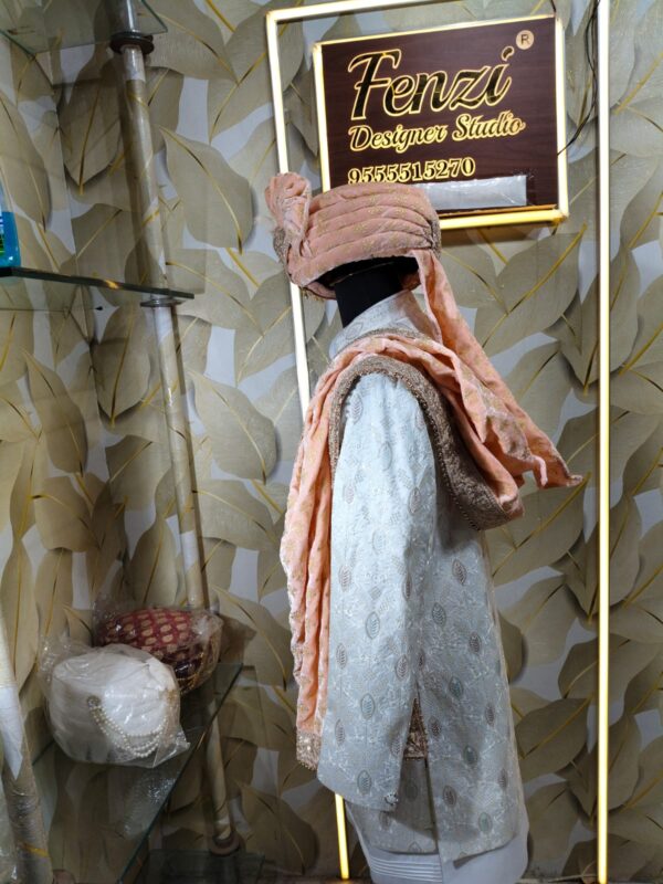 Elegant peach and white sherwani with embellished turban and dupatta displayed at Fenzi Designer Studio.