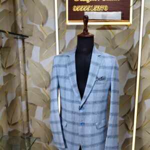 Light blue checked blazer displayed on mannequin at Fenzi Designer Studio.