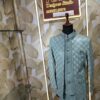Elegant pastel green embroidered men’s designer sherwani displayed on a mannequin at Fenzi Designer Studio.