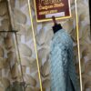 Elegant pastel green embroidered men’s designer sherwani displayed on a mannequin at Fenzi Designer Studio.