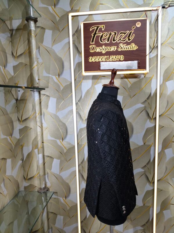 Elegant black designer Jodhpuri with textured geometric pattern and metallic buttons displayed on a mannequin at Fenzi Designer Studio.