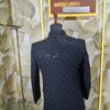 Elegant black designer Jodhpuri with textured geometric pattern and metallic buttons displayed on a mannequin at Fenzi Designer Studio.