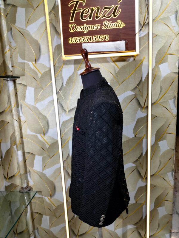 Elegant black designer Jodhpuri with textured geometric pattern and metallic buttons displayed on a mannequin at Fenzi Designer Studio.