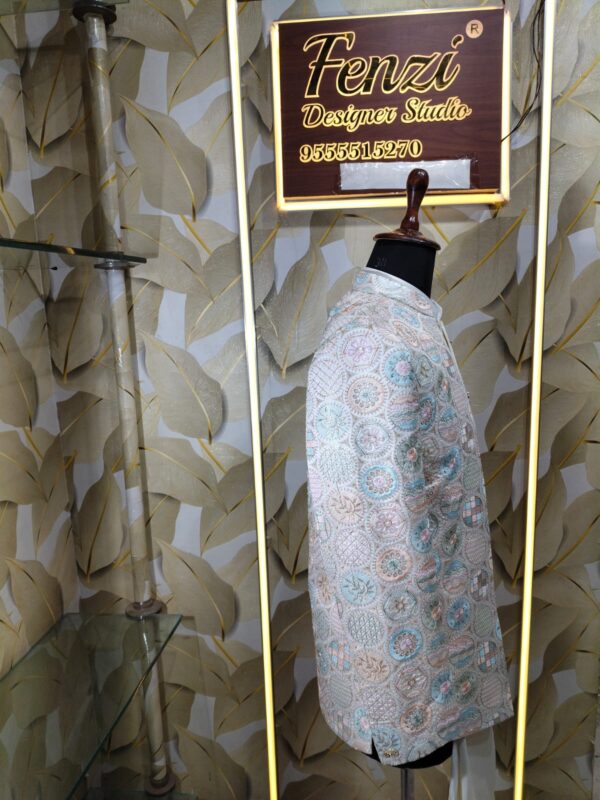 Pastel embroidered Jodhpuri suit displayed on a mannequin at Fenzi Designer Studio.