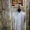 Pastel embroidered Jodhpuri suit displayed on a mannequin at Fenzi Designer Studio.
