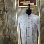 “Pastel floral embroidered Jodhpuri suit displayed on a mannequin at Fenzi Designer Studio.”