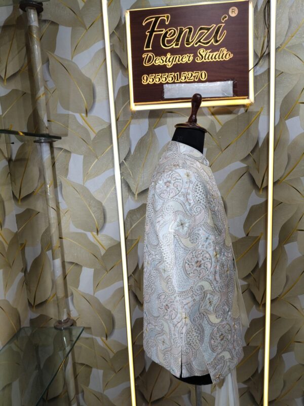 “Elegant ivory embroidered Jodhpuri suit displayed on a mannequin at Fenzi Designer Studio.”