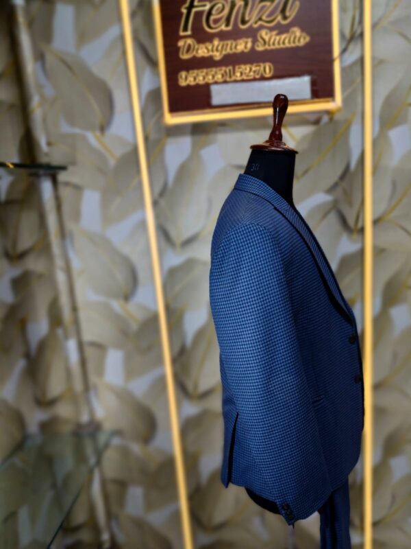 Blue checkered 3-piece men's suit displayed on a mannequin at Fenzi Designer Studio.