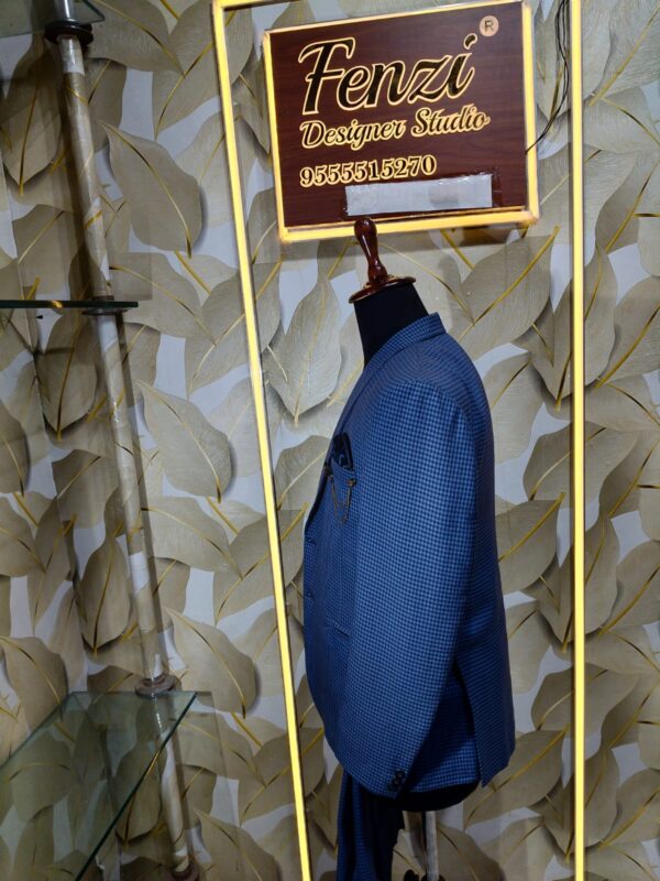 Blue checkered 3-piece men's suit displayed on a mannequin at Fenzi Designer Studio.