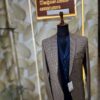 Men’s designer 3-piece suit with a brown micro-check blazer and navy blue waistcoat displayed on a mannequin at Fenzi Designer Studio.”