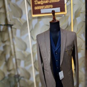 Men’s designer 3-piece suit with a brown micro-check blazer and navy blue waistcoat displayed on a mannequin at Fenzi Designer Studio.”
