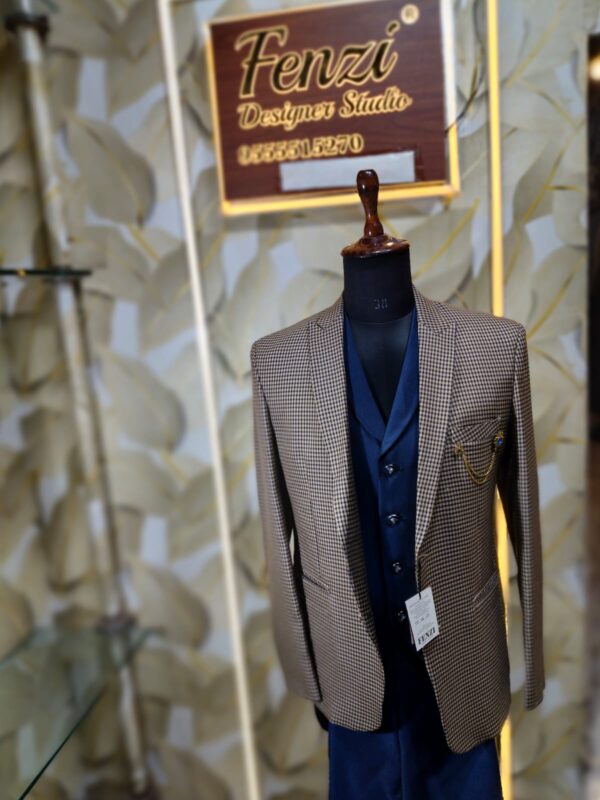 Men’s designer 3-piece suit with a brown micro-check blazer and navy blue waistcoat displayed on a mannequin at Fenzi Designer Studio.”