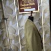 “Three-piece checked suit displayed on a mannequin at Fenzi Designer Studio”