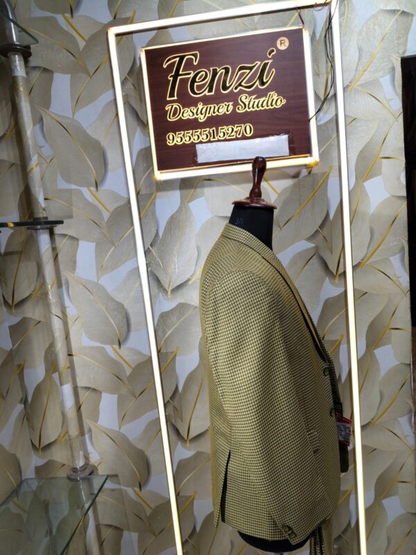 “Three-piece checked suit displayed on a mannequin at Fenzi Designer Studio”
