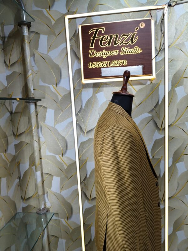 Brown checkered 3-piece men’s suit displayed on a mannequin at Fenzi Designer Studio.