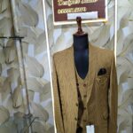 Brown checkered 3-piece men’s suit displayed on a mannequin at Fenzi Designer Studio.
