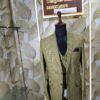 “Three-piece checked suit displayed on a mannequin at Fenzi Designer Studio”