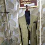 “Three-piece checked suit displayed on a mannequin at Fenzi Designer Studio”