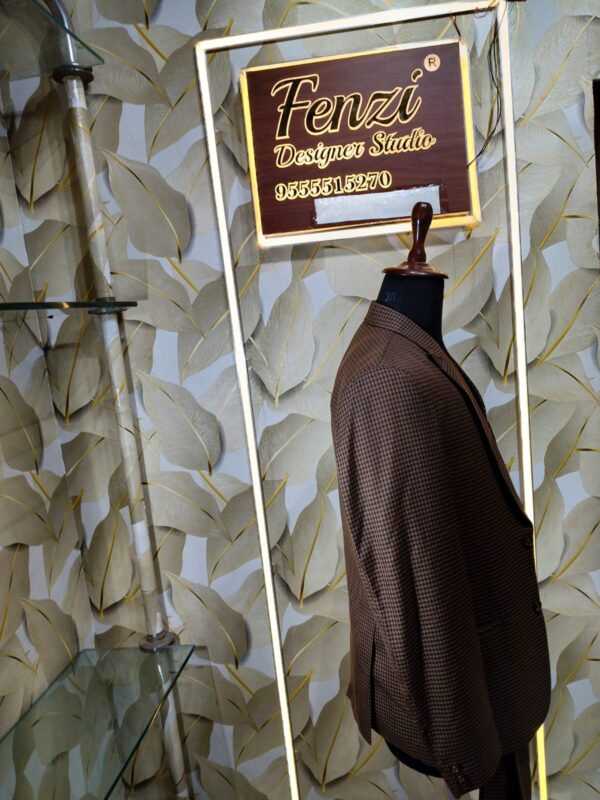Elegant brown checked 3-piece suit displayed on a mannequin with blazer, waistcoat, and trousers.