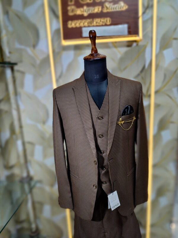 Elegant brown checked 3-piece suit displayed on a mannequin with blazer, waistcoat, and trousers.