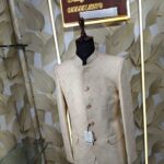 Cream-gold designer Jodhpuri suit on a mannequin